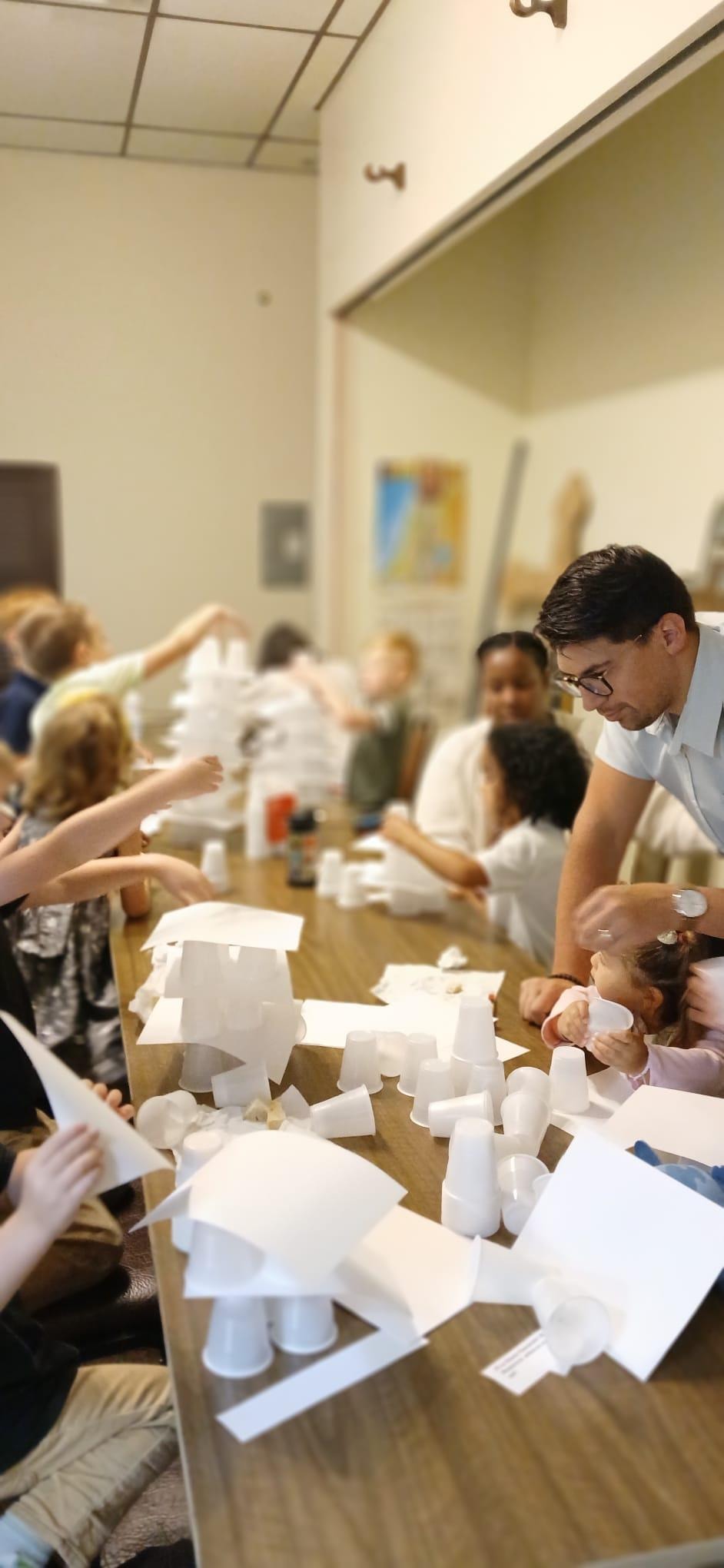 The full Sunday School class building Tower of Babel structures — the whole room alive with activity