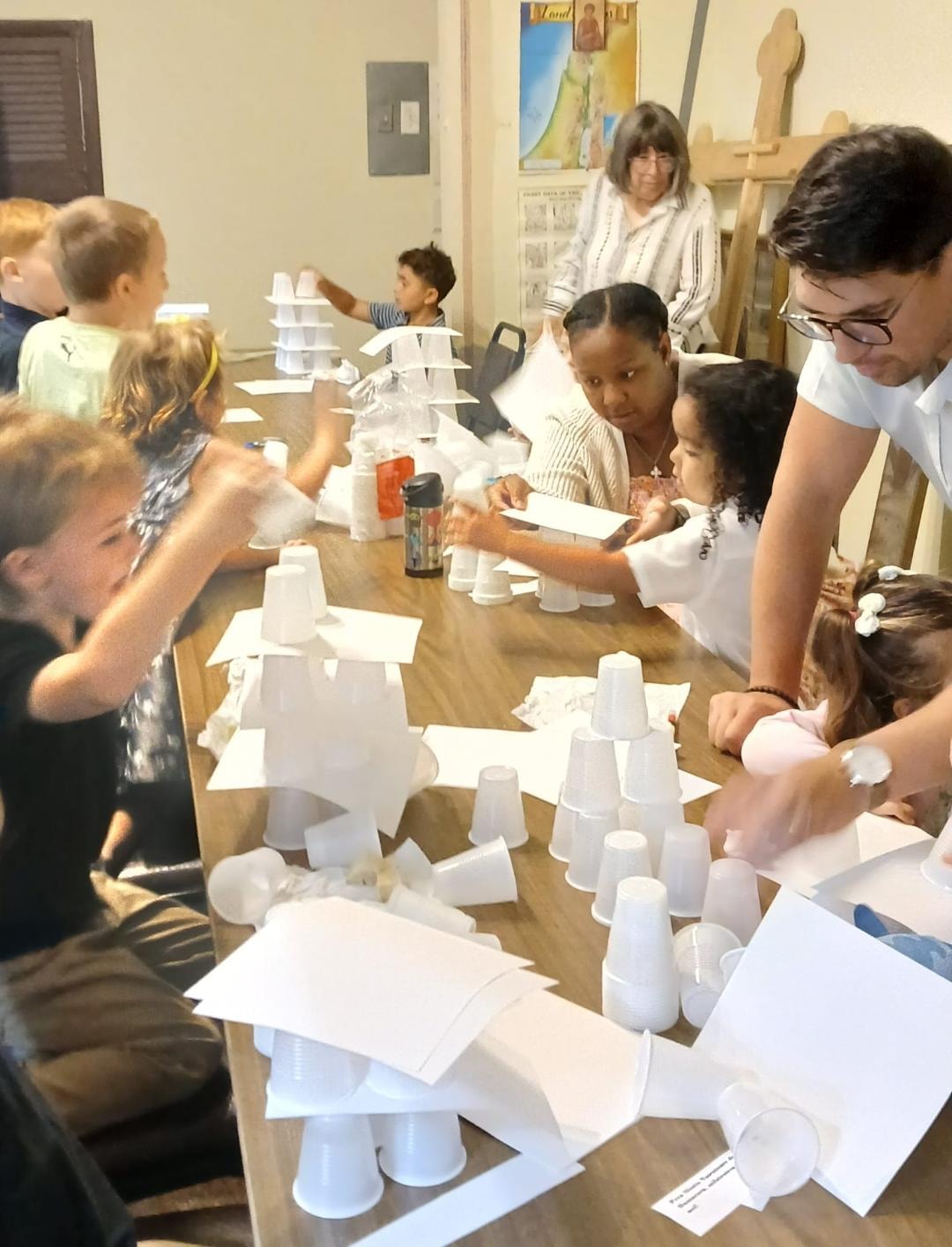 Adults and children working together at the Tower of Babel activity